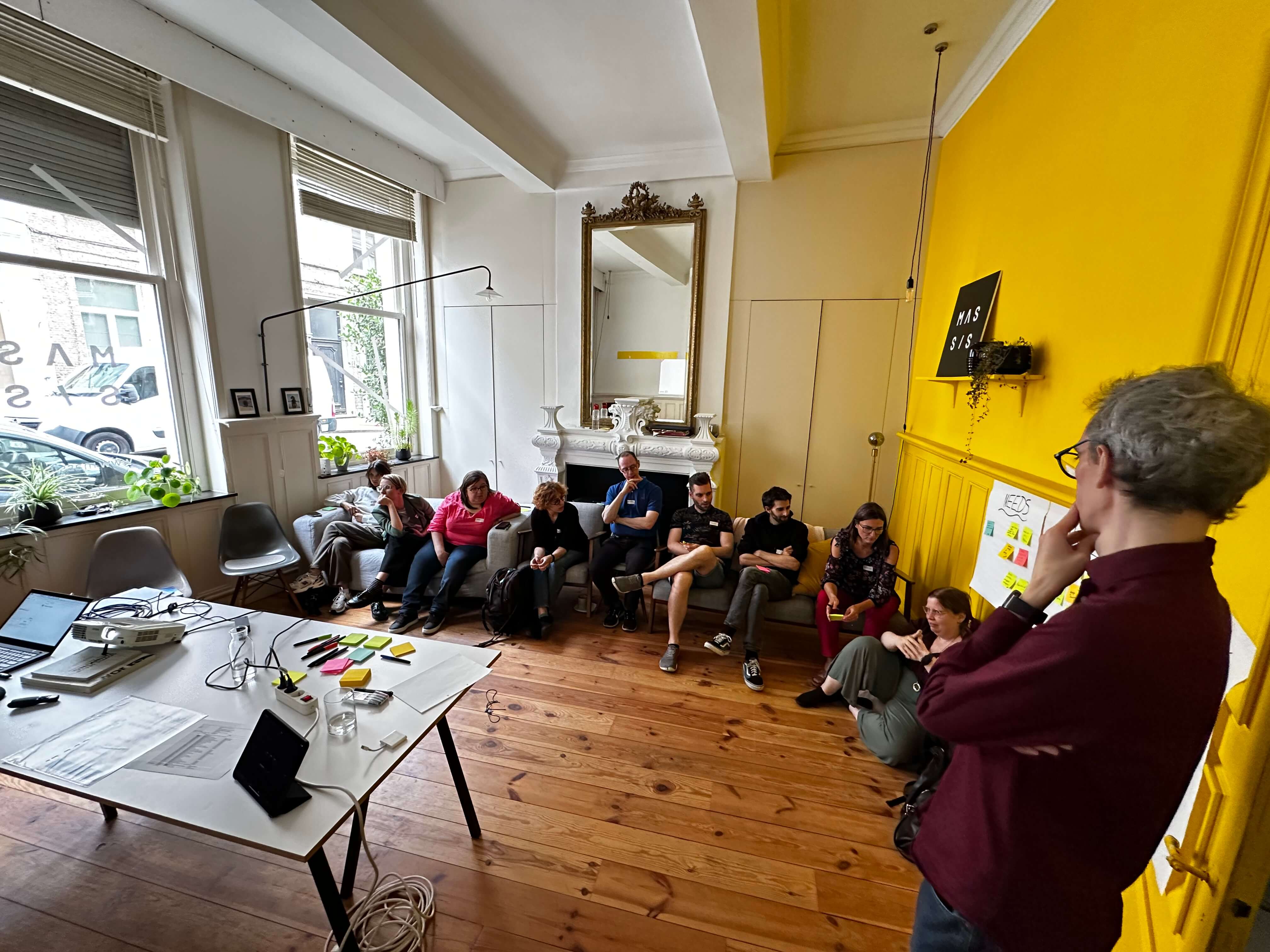The team of Eleven Ways sitting on couches and discussing during the workshop with Bjièn
